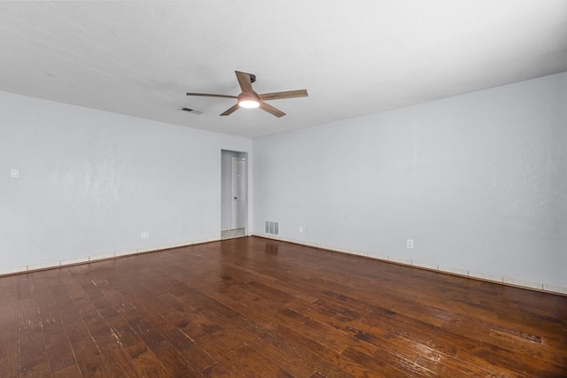 spare room featuring visible vents, a ceiling fan, and hardwood / wood-style floors