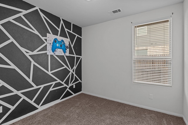 carpeted empty room with visible vents and baseboards