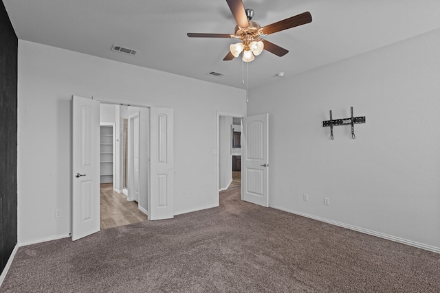 unfurnished bedroom featuring carpet floors, baseboards, and visible vents