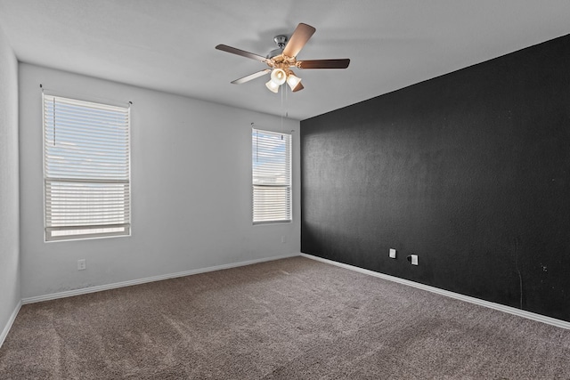 empty room featuring ceiling fan, baseboards, and carpet flooring