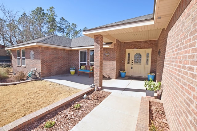 view of exterior entry featuring a patio