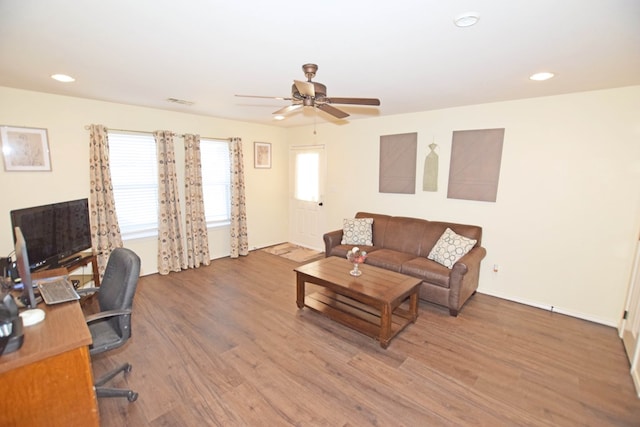 living room with hardwood / wood-style flooring and ceiling fan