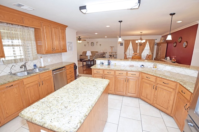 kitchen featuring sink, ornamental molding, a kitchen island, ceiling fan with notable chandelier, and stainless steel dishwasher