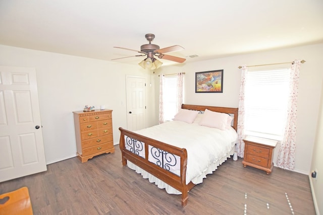 bedroom with dark wood-type flooring and ceiling fan