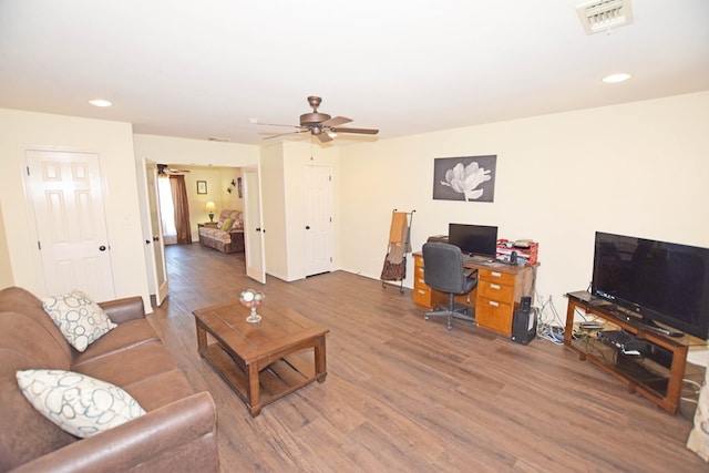 living room with dark hardwood / wood-style floors and ceiling fan