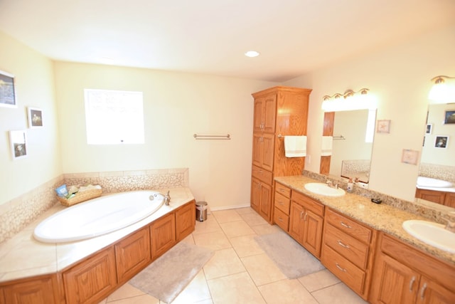 bathroom with vanity, a tub, and tile patterned floors