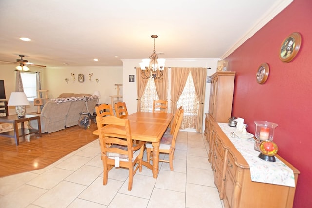 dining room featuring ornamental molding, ceiling fan with notable chandelier, and light tile patterned flooring