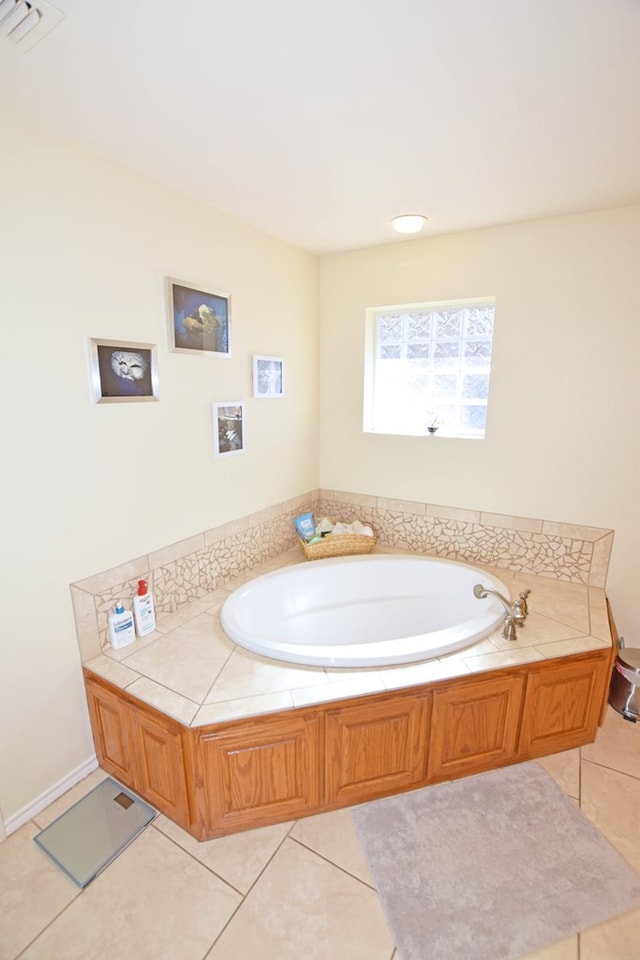 bathroom featuring tile patterned flooring and a bath