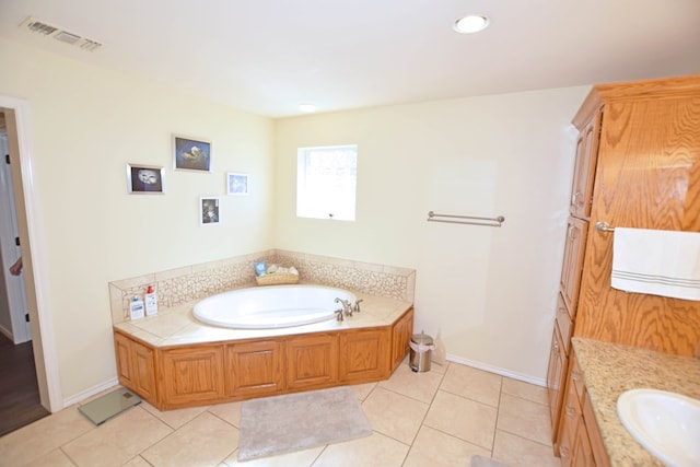 bathroom with tile patterned flooring, vanity, and a tub to relax in