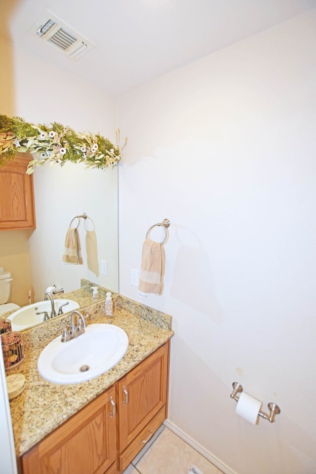 bathroom with vanity, toilet, and tile patterned flooring