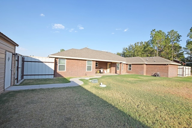 rear view of house featuring a patio and a lawn