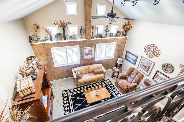 living room with ceiling fan and high vaulted ceiling