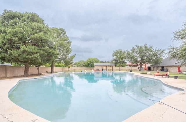 view of swimming pool featuring a patio area