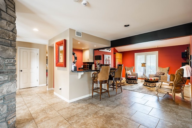 kitchen featuring a breakfast bar area and kitchen peninsula