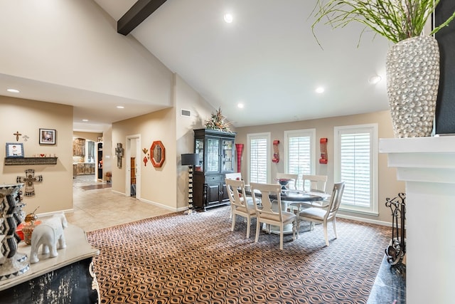 dining area featuring tile patterned floors and high vaulted ceiling