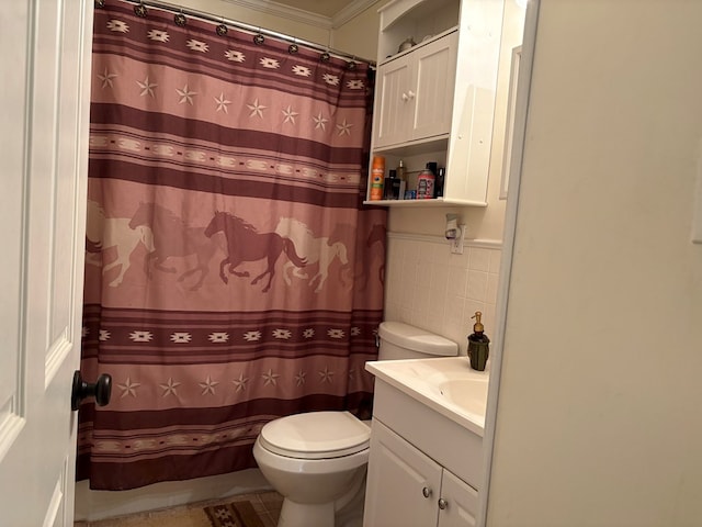 bathroom with toilet, curtained shower, tile walls, and vanity