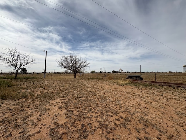 view of yard featuring a rural view and fence