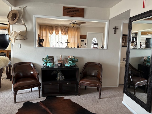 sitting room featuring a ceiling fan and carpet floors