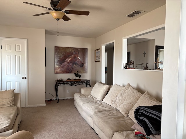 living room with visible vents, baseboards, carpet, and a ceiling fan