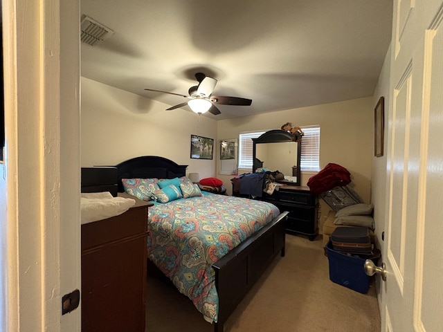 carpeted bedroom featuring visible vents and a ceiling fan