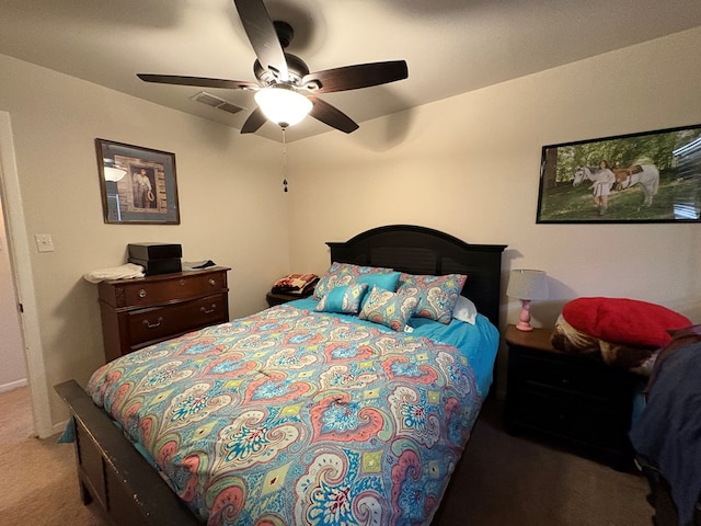 carpeted bedroom featuring visible vents and ceiling fan