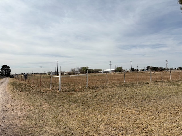 view of yard featuring a rural view and fence