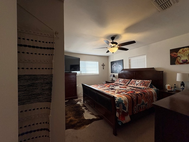 bedroom with visible vents, carpet floors, and ceiling fan