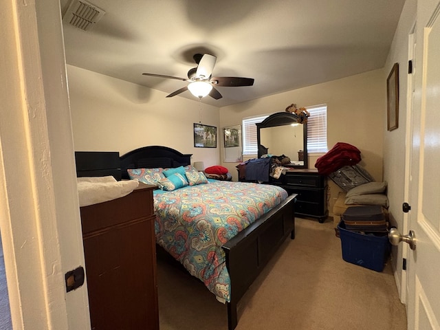 bedroom featuring visible vents, light carpet, and ceiling fan