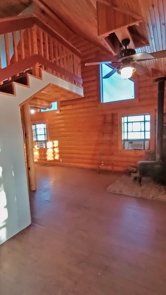 bonus room with ceiling fan, log walls, high vaulted ceiling, hardwood / wood-style floors, and wood ceiling