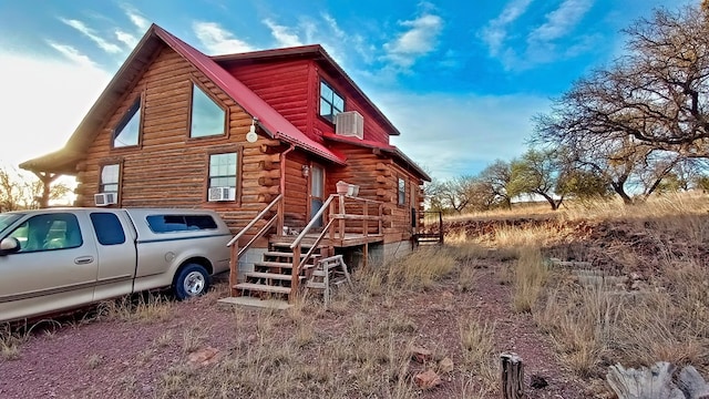 rear view of property with cooling unit