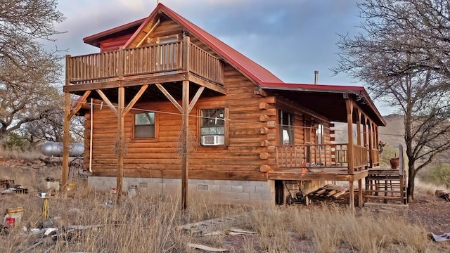 view of property exterior with a balcony and cooling unit