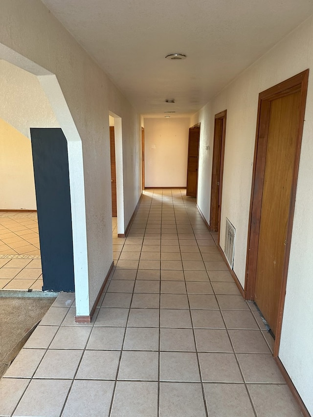 hallway featuring light tile patterned floors