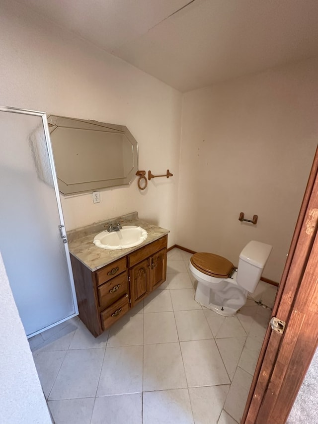 bathroom with vanity, tile patterned floors, and toilet