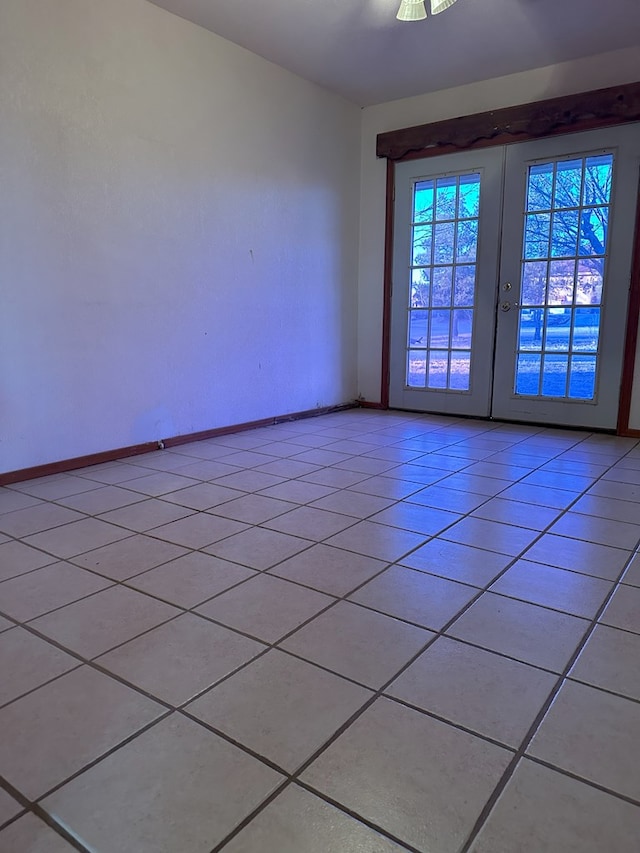 unfurnished room with light tile patterned flooring and french doors