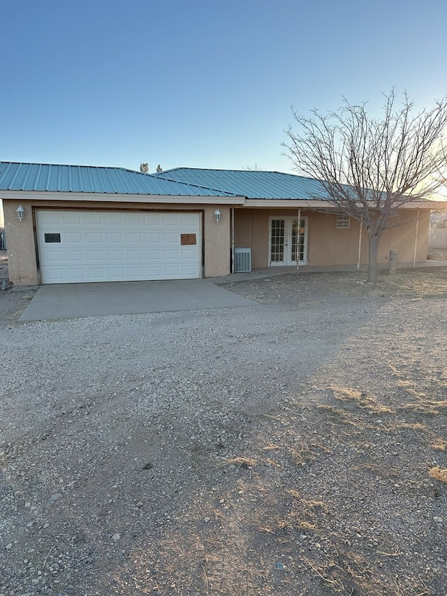 view of front of house featuring a garage and french doors