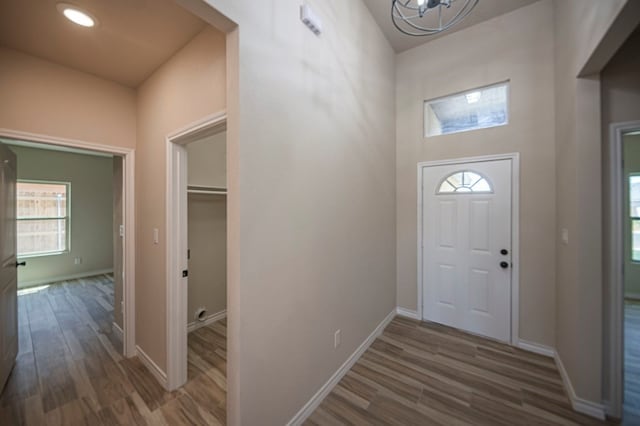 foyer featuring a chandelier and dark wood-type flooring