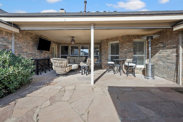 view of patio with ceiling fan and an outdoor living space