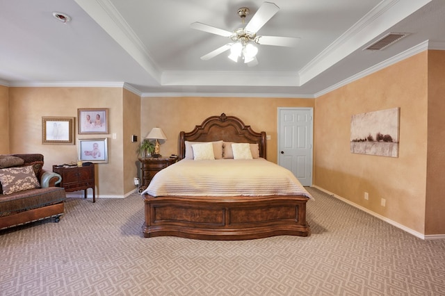 carpeted bedroom featuring a tray ceiling, visible vents, ceiling fan, and baseboards