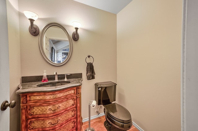 bathroom with vanity, baseboards, and tile patterned floors