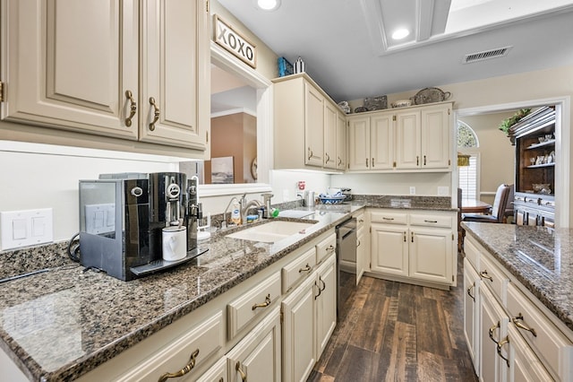 kitchen with stone counters, recessed lighting, dark wood-style flooring, a sink, and visible vents