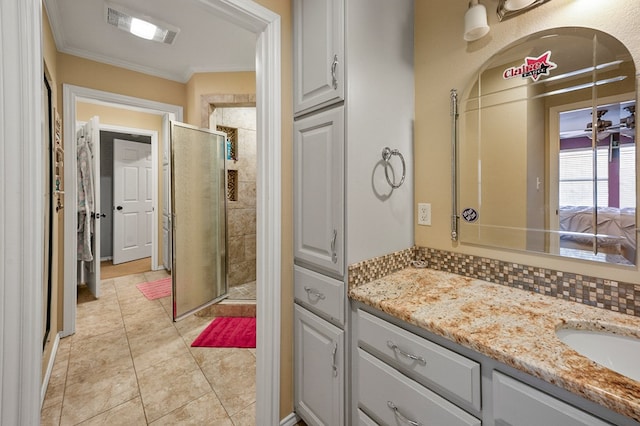 full bath featuring visible vents, tile patterned flooring, crown molding, vanity, and a shower stall