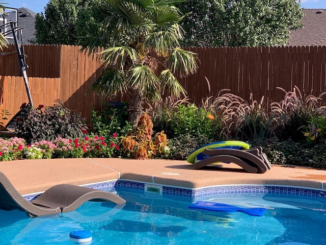 view of swimming pool featuring fence and a fenced in pool