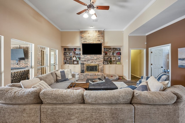 living area with ceiling fan, built in shelves, visible vents, ornamental molding, and a brick fireplace