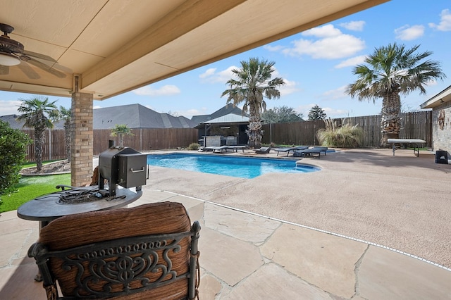 view of pool featuring a fenced in pool, a patio, a fenced backyard, ceiling fan, and a gazebo