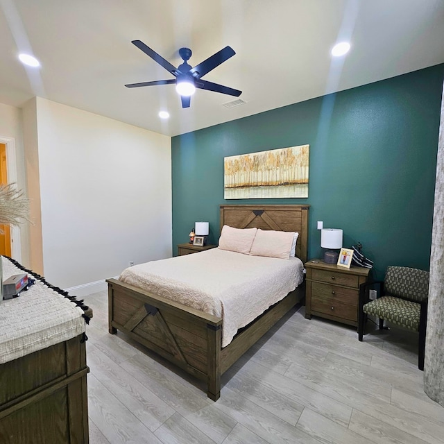 bedroom with a ceiling fan, recessed lighting, visible vents, and light wood-style floors