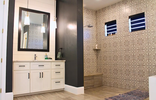 full bathroom with walk in shower and vanity