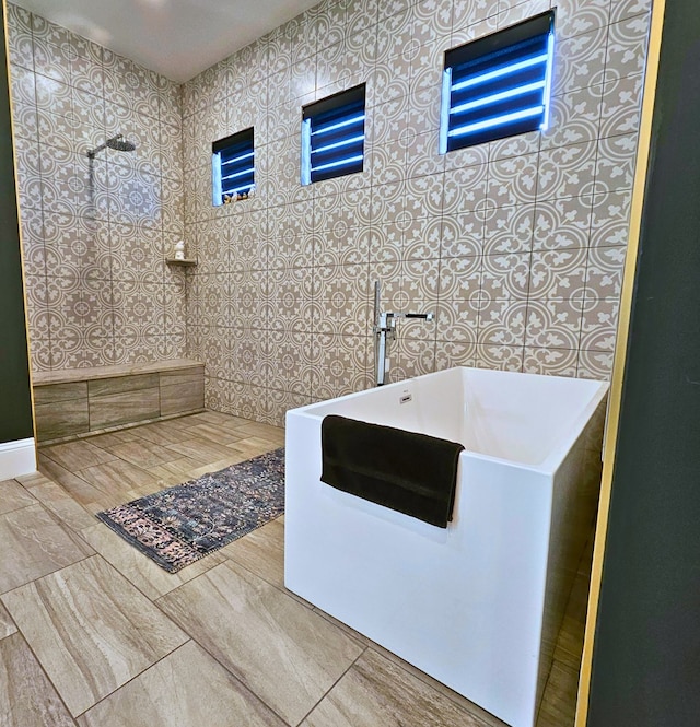 bathroom featuring a freestanding tub and walk in shower