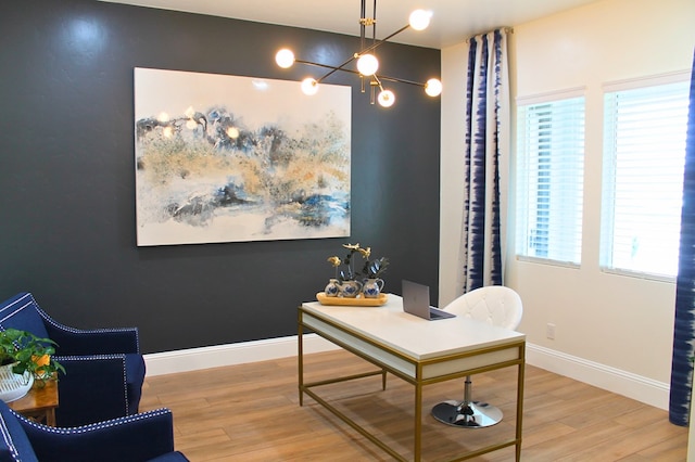 office area with a chandelier, wood finished floors, and baseboards