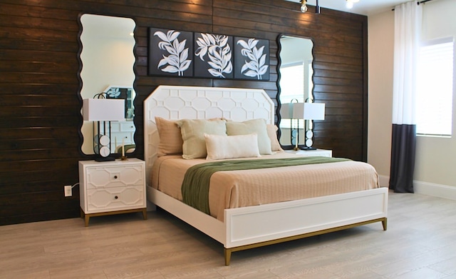 bedroom featuring light wood-style floors and baseboards