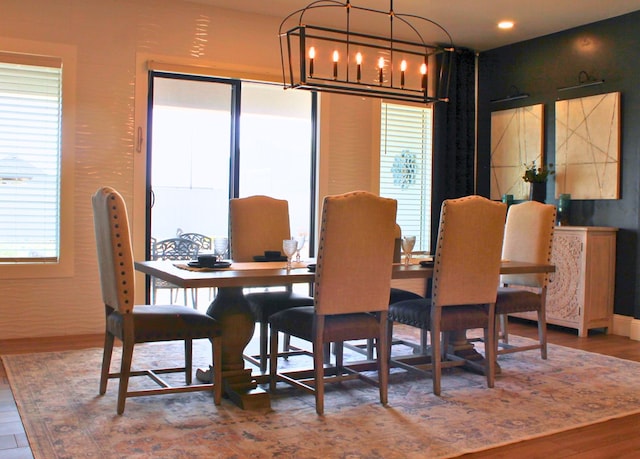 dining room featuring wood finished floors and an inviting chandelier